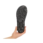 Suela negra con textura antideslizante y costuras blancas del zapato Barevene Mary Jane, sostenida por una mano