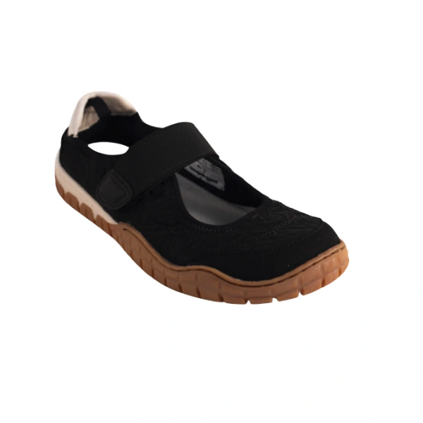 Zapato Coqueflex Lira negro con tira elástica de velcro, talón blanco y suela de goma color miel, vista de tres cuartos