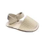 Sandalia menorquina infantil de piel color arena con tira de velcro en el talón y suela cosida, vista lateral